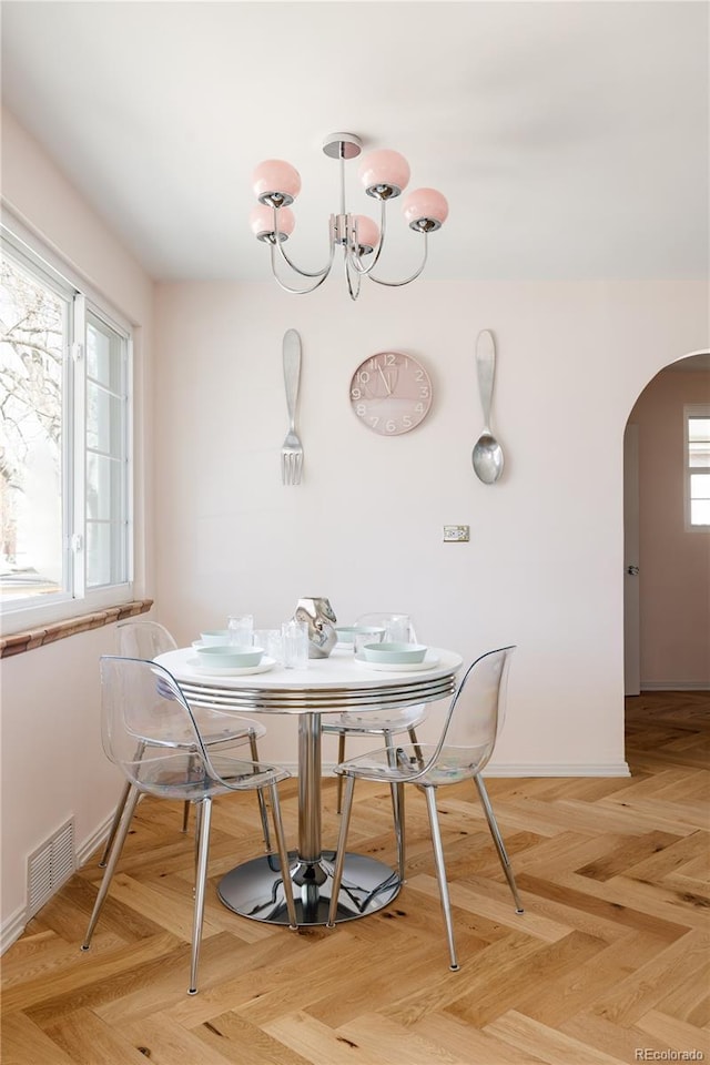 1010 N Jasmine St, Denver, CO 80220 - dining area with arched walkways and a chandelier