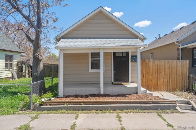 4636 Leaf Ct, Denver, CO 80216 - view of front facade with roof with shingles, fence, and a porch