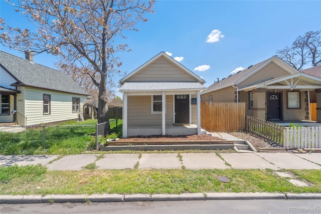 4636 Leaf Ct, Denver, CO 80216 - view of front facade featuring a porch and a fenced front yard