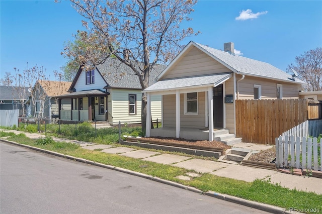 4636 Leaf Ct, Denver, CO 80216 - bungalow with a porch, a shingled roof, and a chimney