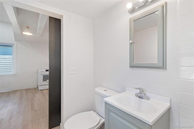 4636 Leaf Ct, Denver, CO 80216 - half bath featuring wood finished floors, vanity, and toilet