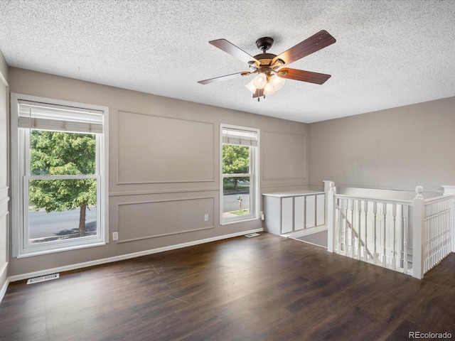 1642 S Salida Way, Aurora, CO 80017 - spare room featuring dark wood finished floors, a textured ceiling, and ceiling fan