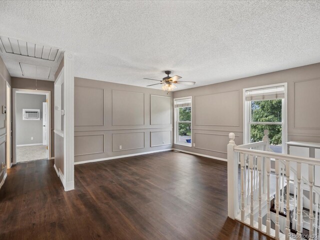 1642 S Salida Way, Aurora, CO 80017 - spare room featuring attic access, a decorative wall, dark wood-style floors, ceiling fan, and an AC wall unit