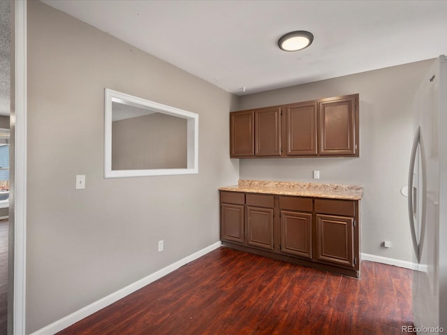 1642 S Salida Way, Aurora, CO 80017 - kitchen featuring baseboards, dark wood finished floors, and freestanding refrigerator