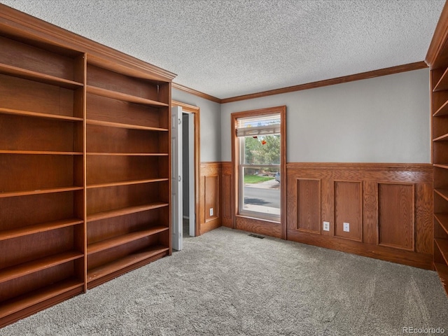 1642 S Salida Way, Aurora, CO 80017 - unfurnished bedroom featuring a wainscoted wall, ornamental molding, carpet floors, and a textured ceiling