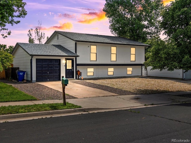 1642 S Salida Way, Aurora, CO 80017 - tri-level home with an attached garage, concrete driveway, and roof with shingles