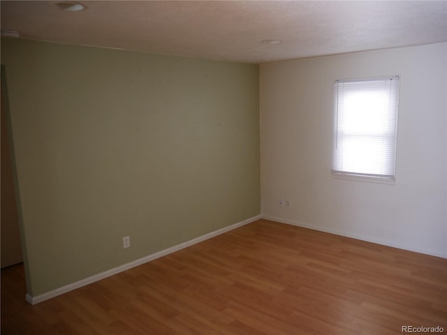 empty room with hardwood / wood-style floors