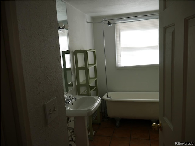 bathroom featuring tile patterned flooring and a bath