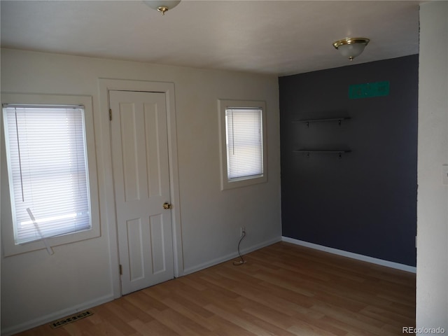 interior space with plenty of natural light and light hardwood / wood-style flooring