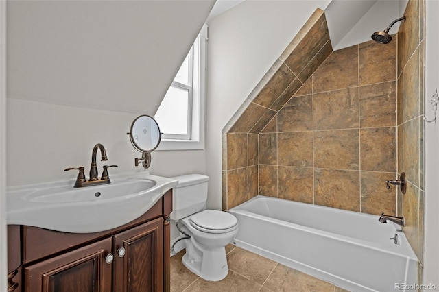 full bathroom with lofted ceiling, toilet, tiled shower / bath, vanity, and tile patterned flooring