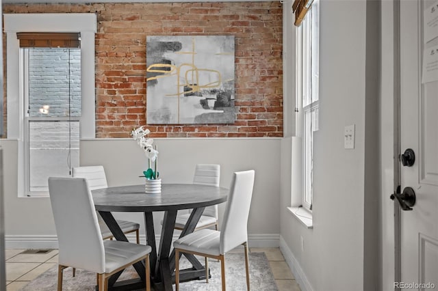 tiled dining area with brick wall