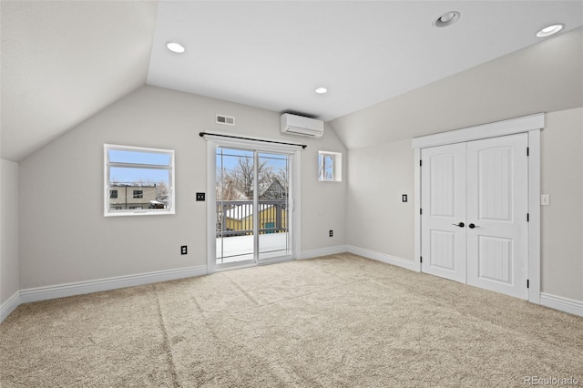 bonus room with lofted ceiling, an AC wall unit, and carpet flooring