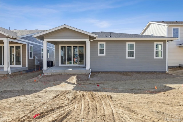 rear view of property with central air condition unit