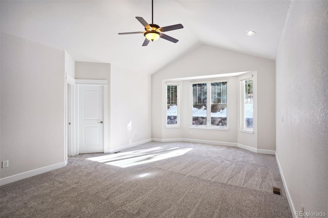 spare room featuring ceiling fan, carpet, and vaulted ceiling