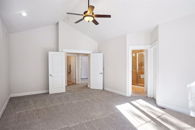 unfurnished bedroom with ceiling fan, vaulted ceiling, light colored carpet, and ensuite bath