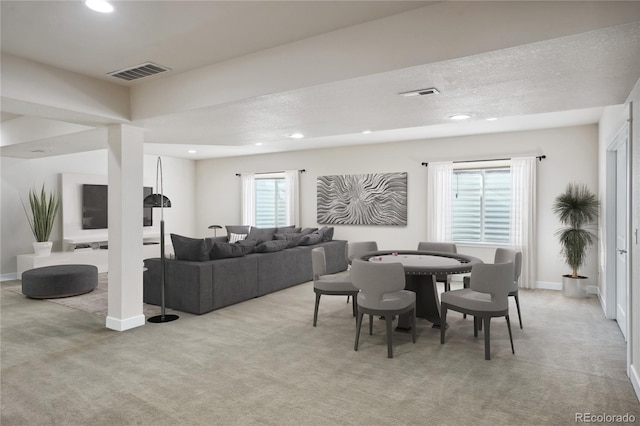 dining room with a textured ceiling and light carpet