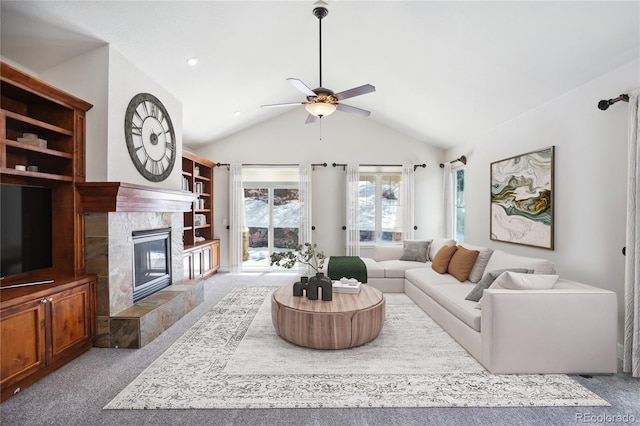 carpeted living room with ceiling fan, lofted ceiling, and a fireplace