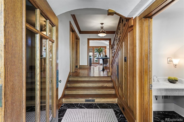 hallway featuring ornamental molding