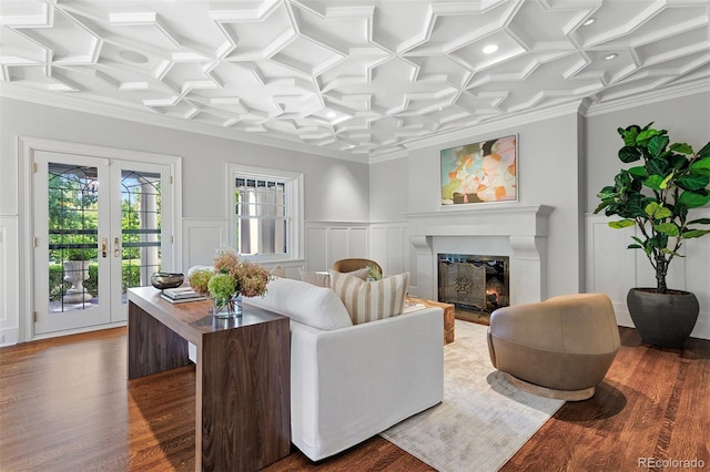 living room with coffered ceiling, hardwood / wood-style flooring, and crown molding