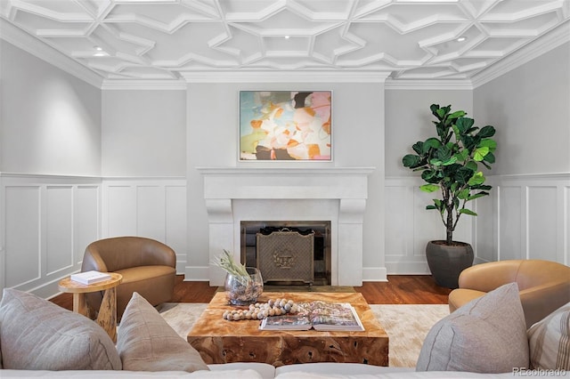 living room with ornamental molding, coffered ceiling, and hardwood / wood-style floors