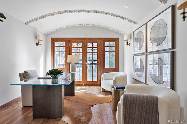 home office featuring lofted ceiling, dark hardwood / wood-style floors, and french doors