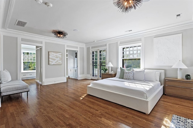 bedroom featuring connected bathroom, dark hardwood / wood-style floors, and crown molding