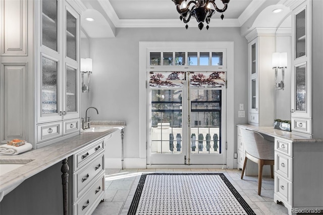 interior space with crown molding, tile patterned flooring, sink, and a notable chandelier