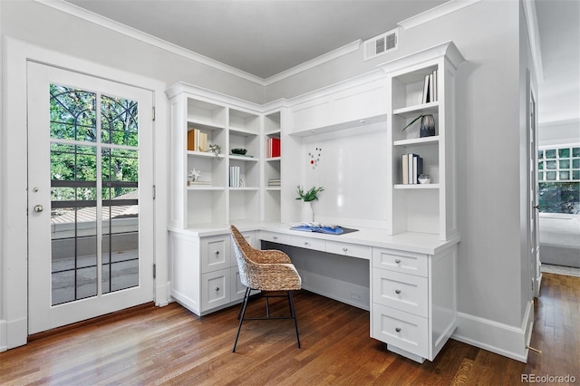 home office with dark hardwood / wood-style floors, built in desk, and crown molding