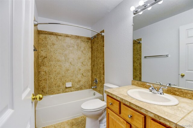 full bathroom with washtub / shower combination, tile patterned flooring, vanity, and toilet