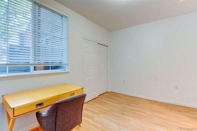 office area with light wood-type flooring and baseboards