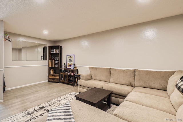 living area featuring baseboards and wood finished floors