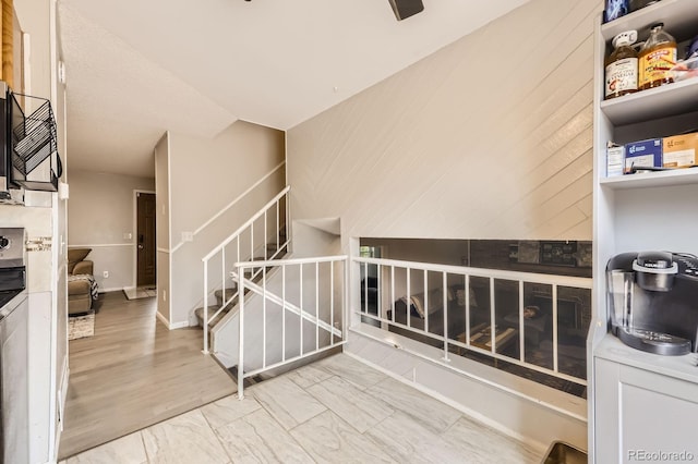 interior space with marble finish floor, stairs, and baseboards