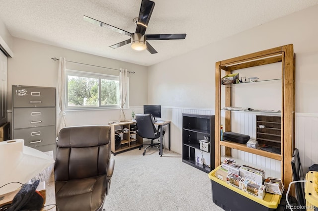 office area with carpet flooring, a textured ceiling, and a ceiling fan