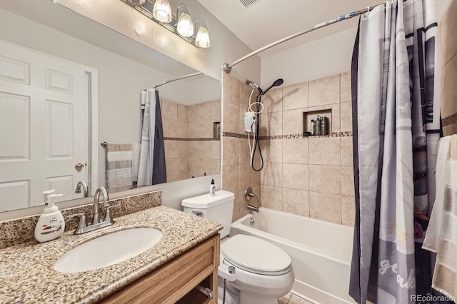 bathroom featuring visible vents, vanity, toilet, and shower / tub combo