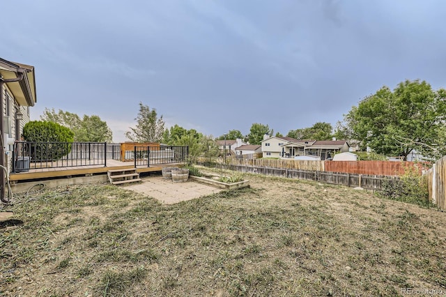 view of yard with a deck and fence