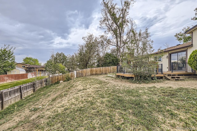 view of yard featuring a fenced backyard and a wooden deck