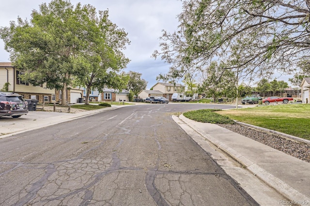 view of street with a residential view and curbs