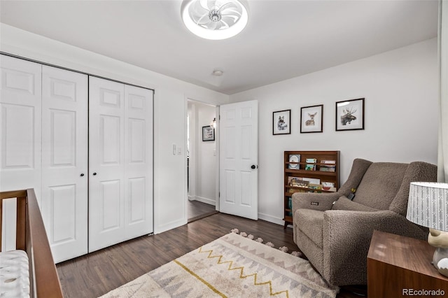 bedroom featuring dark wood-type flooring, a closet, and baseboards