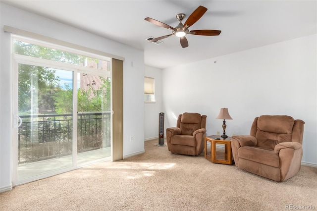 sitting room featuring ceiling fan and light colored carpet