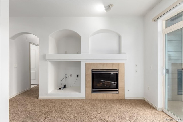 unfurnished living room featuring a fireplace and carpet floors