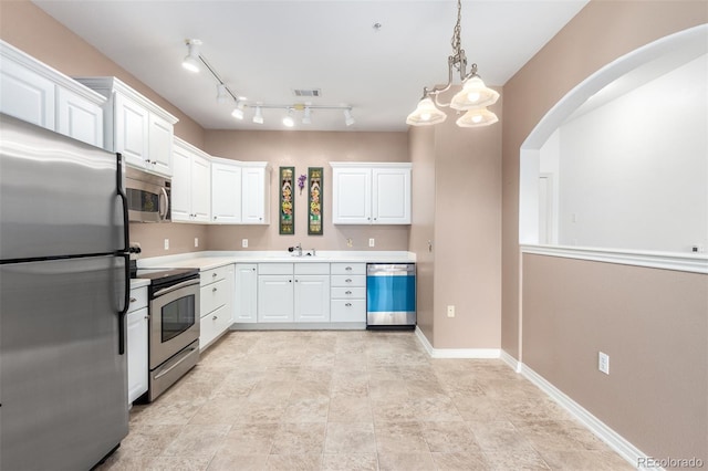 kitchen with pendant lighting, stainless steel appliances, an inviting chandelier, and white cabinets