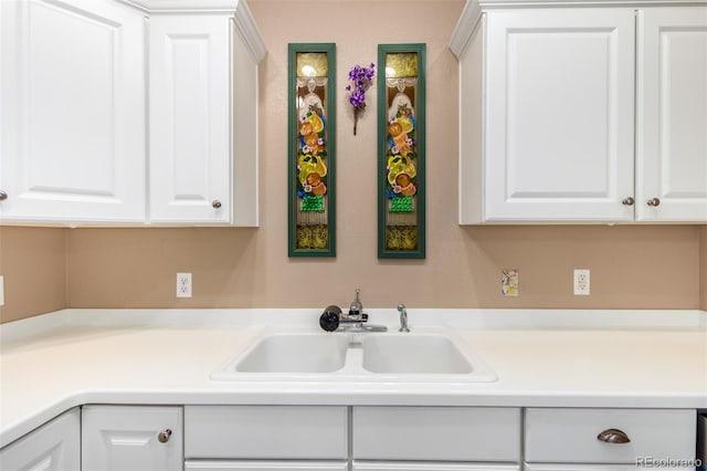 kitchen featuring sink and white cabinets