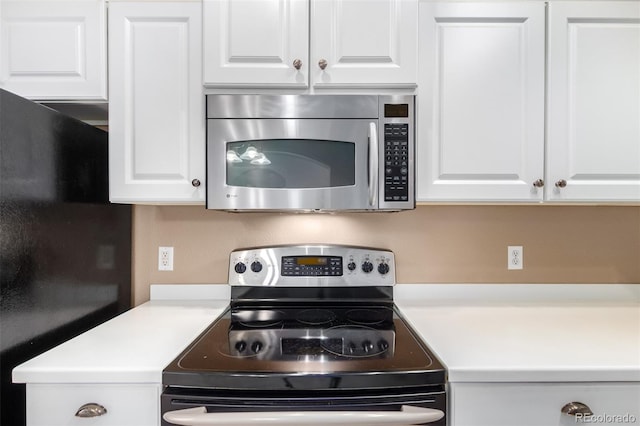 kitchen with appliances with stainless steel finishes and white cabinetry