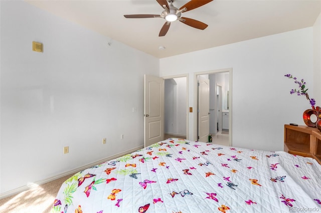 carpeted bedroom with ceiling fan and connected bathroom