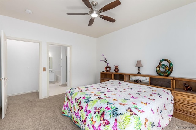 carpeted bedroom featuring ensuite bath and ceiling fan