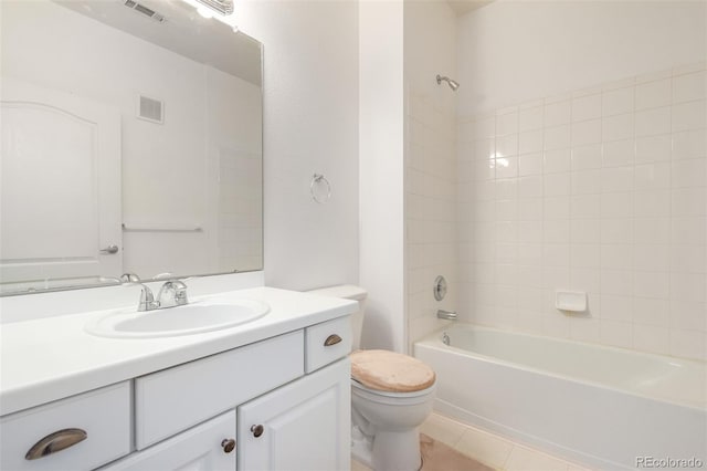 full bathroom featuring tile patterned flooring, vanity, toilet, and tiled shower / bath