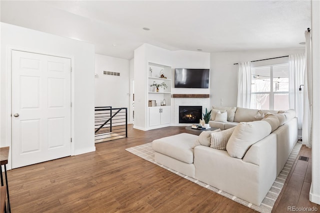 living room featuring hardwood / wood-style flooring and built in features