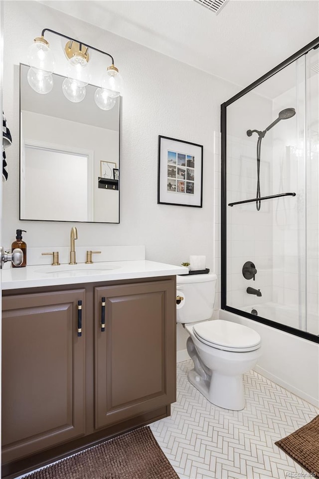 full bathroom featuring tile patterned floors, vanity, bath / shower combo with glass door, and toilet