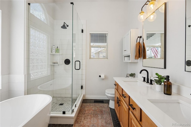 full bathroom with toilet, plenty of natural light, vanity, and shower with separate bathtub