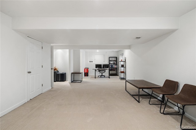 sitting room featuring light colored carpet